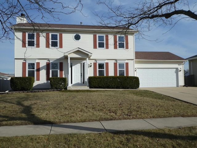 colonial-style house with a garage and a front yard