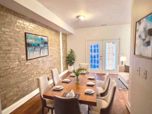 dining area with wood-type flooring and french doors