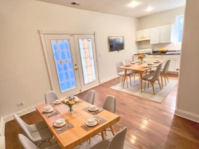 dining space with french doors and hardwood / wood-style floors