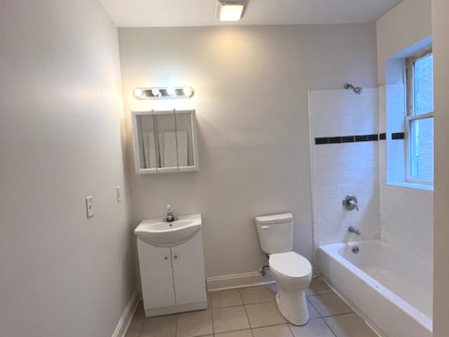 full bathroom featuring tile patterned flooring, tiled shower / bath combo, toilet, and vanity