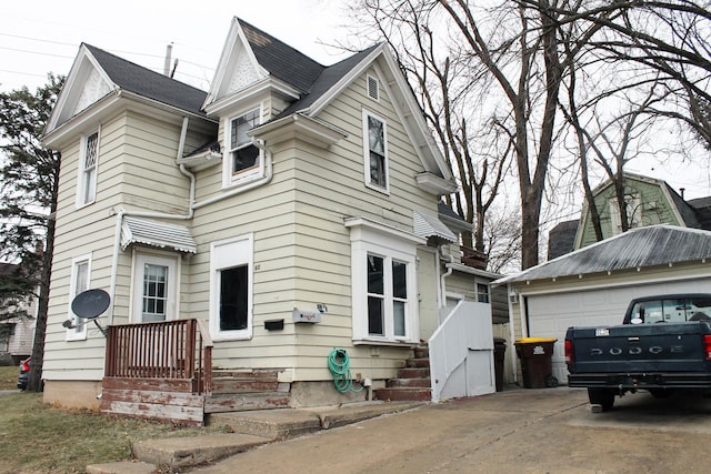 view of front facade featuring a garage and an outdoor structure