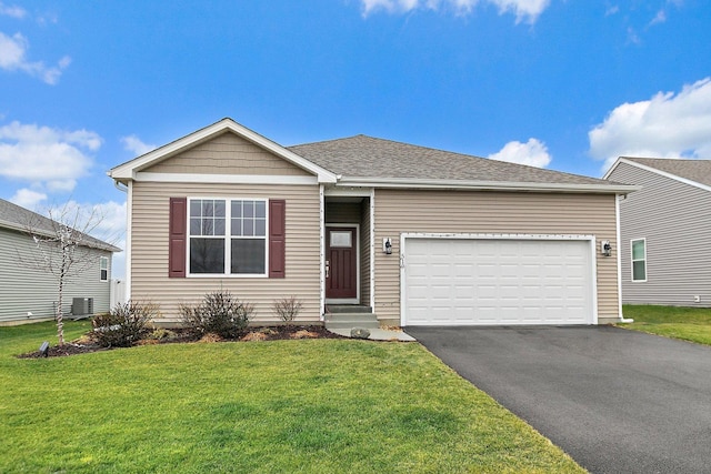 view of front of house with central AC unit, a garage, and a front yard