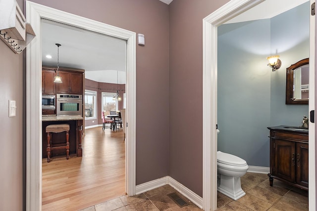 bathroom featuring tile patterned floors, vanity, and toilet