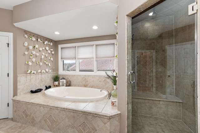 bathroom with tile patterned floors and shower with separate bathtub