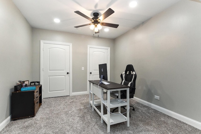 carpeted home office featuring ceiling fan