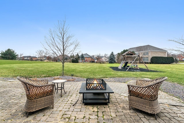 view of patio / terrace with a playground and an outdoor fire pit