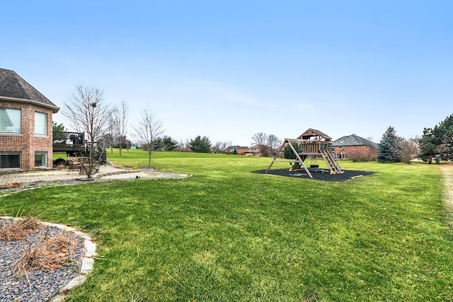 view of yard featuring a playground and a deck