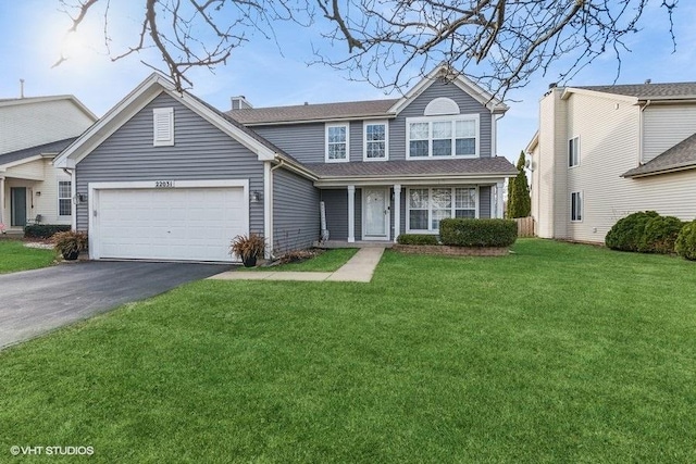 view of front of home featuring a garage and a front lawn