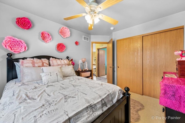 bedroom featuring carpet, ceiling fan, and a closet