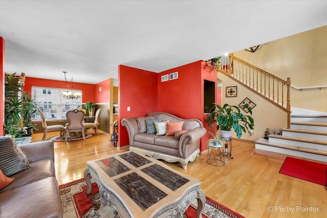 living room with wood-type flooring and a chandelier