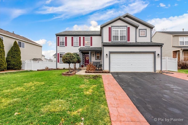 view of front of home with a garage and a front yard