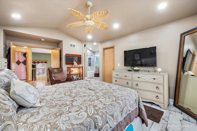 bedroom featuring ceiling fan, lofted ceiling, and ensuite bathroom