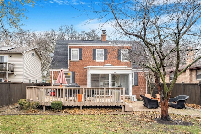 rear view of property with an outdoor living space and a deck