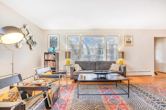 living room featuring hardwood / wood-style floors, radiator heating unit, and a baseboard radiator