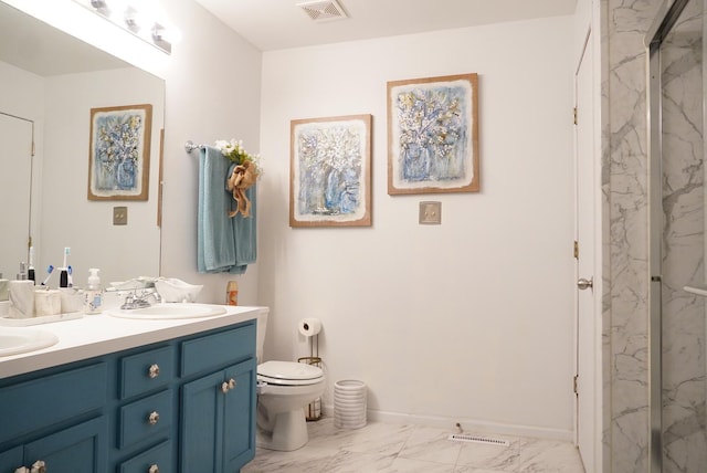 bathroom with vanity, a shower with shower door, and toilet