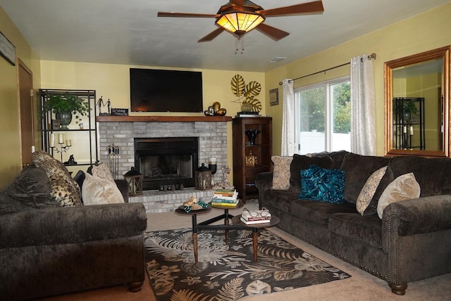 living room with carpet flooring, ceiling fan, and a fireplace