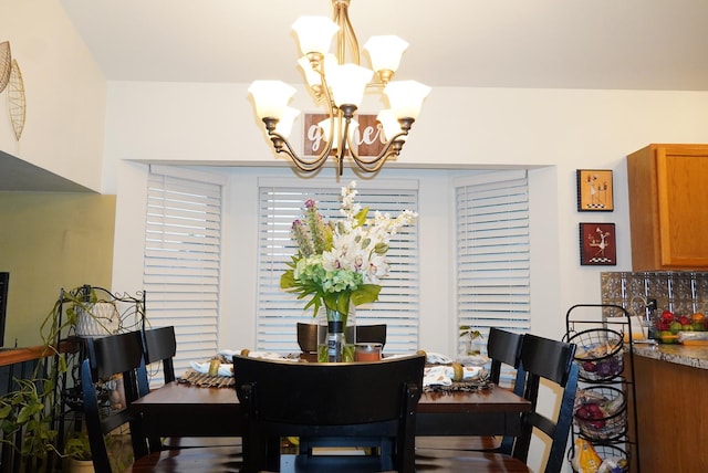 dining area featuring an inviting chandelier