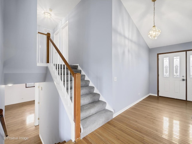 entrance foyer with wood-type flooring and a notable chandelier