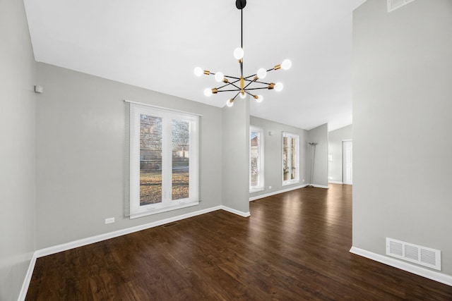 unfurnished living room featuring dark hardwood / wood-style flooring, vaulted ceiling, and a notable chandelier