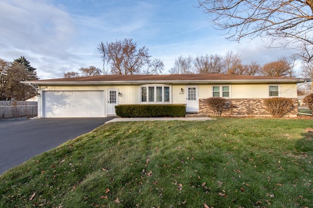 ranch-style house featuring a garage and a front lawn