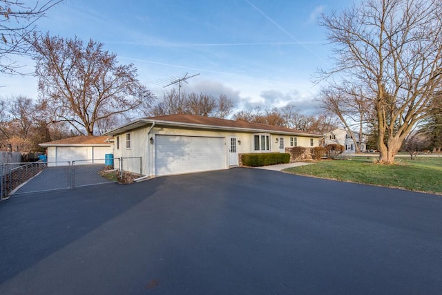 single story home featuring a front lawn and a garage