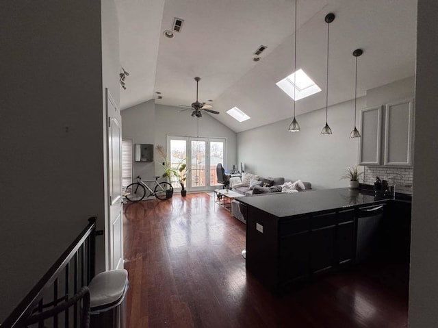 kitchen featuring pendant lighting, lofted ceiling with skylight, ceiling fan, dark hardwood / wood-style floors, and decorative backsplash