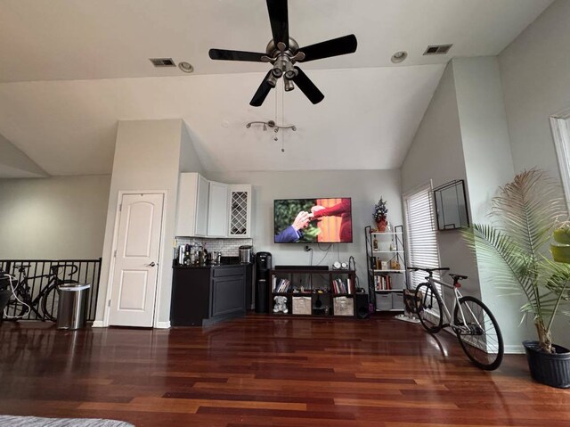 living room featuring dark hardwood / wood-style flooring, ceiling fan, and lofted ceiling