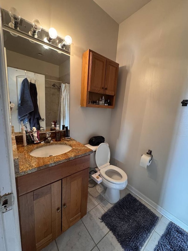 bathroom with tile patterned flooring, vanity, toilet, and walk in shower