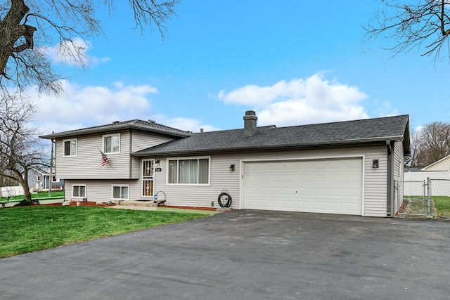 tri-level home with a front lawn and a garage