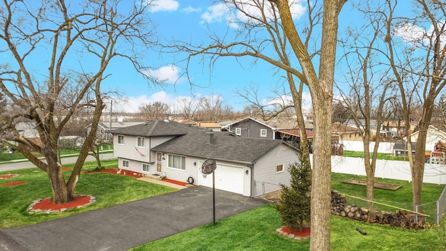 view of front of home featuring a front yard and a garage