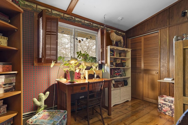 office featuring wood walls, lofted ceiling, and hardwood / wood-style flooring