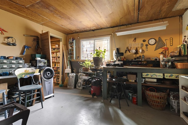 misc room with a workshop area, concrete floors, and wooden ceiling