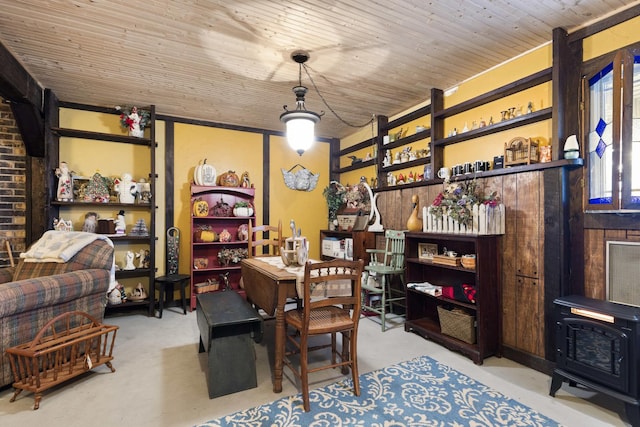 office space with a wood stove and wooden ceiling