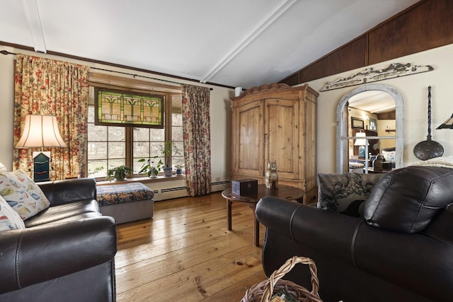 living room featuring light hardwood / wood-style floors, lofted ceiling, and a baseboard radiator