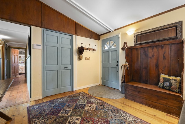 foyer entrance featuring light hardwood / wood-style floors and vaulted ceiling