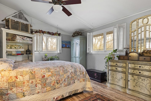 bedroom with ceiling fan, crown molding, lofted ceiling, and hardwood / wood-style flooring