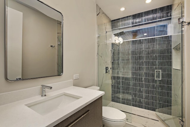 full bath with a stall shower, vanity, toilet, and recessed lighting