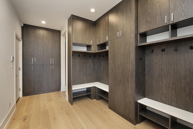 mudroom with recessed lighting, baseboards, and light wood finished floors