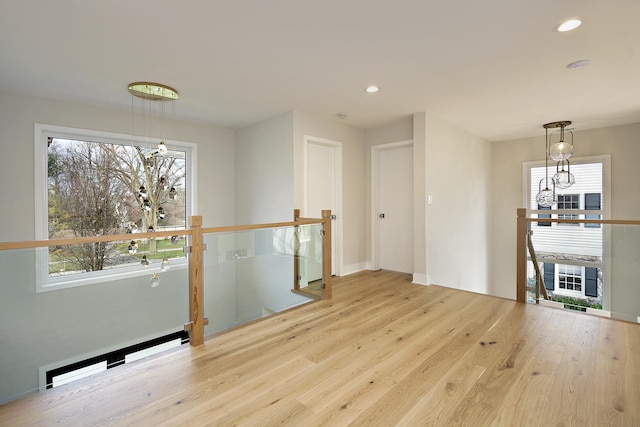 interior space with baseboards, wood finished floors, and recessed lighting