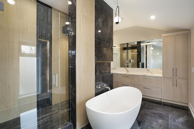 full bathroom featuring a stall shower, a soaking tub, vaulted ceiling, and vanity