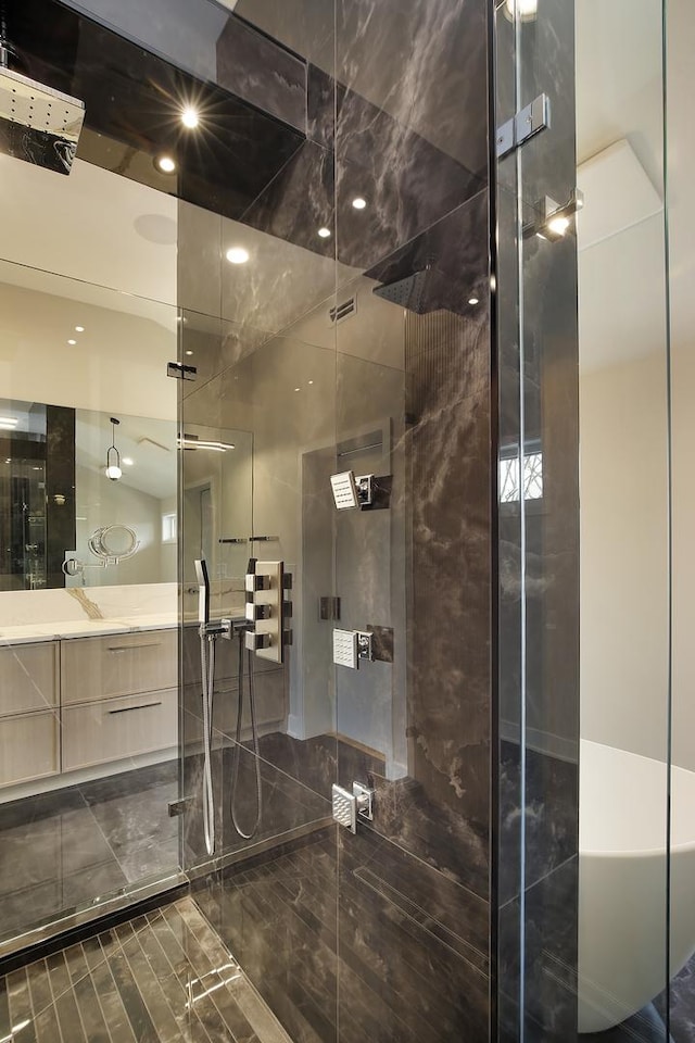 full bathroom featuring a shower stall and vanity