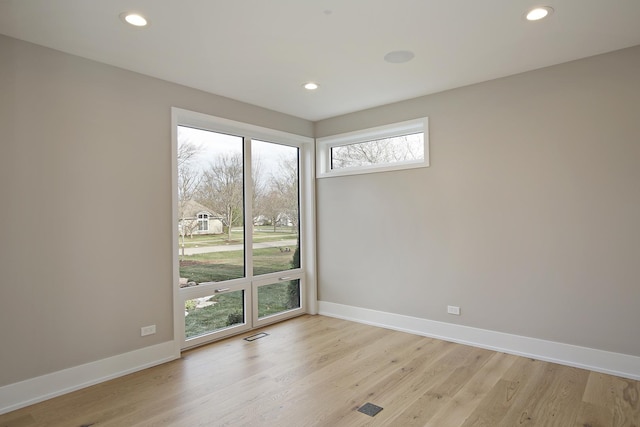 unfurnished room featuring light wood-style floors, recessed lighting, and baseboards