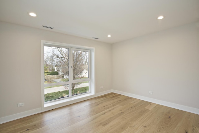 spare room with baseboards, recessed lighting, visible vents, and light wood-style floors