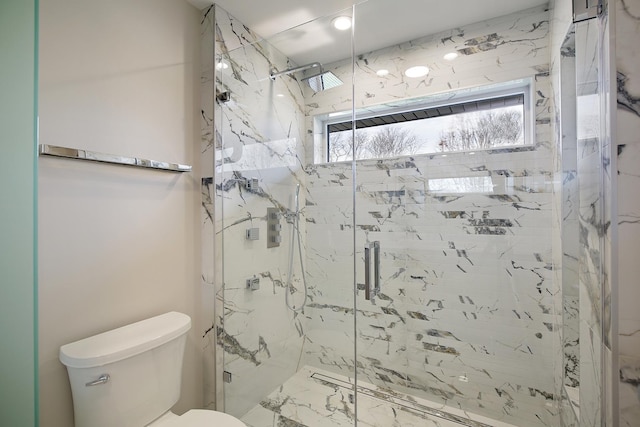 full bath featuring marble finish floor, a marble finish shower, and toilet