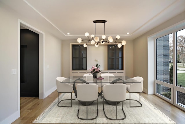 dining area with an inviting chandelier, baseboards, light wood-style floors, and recessed lighting