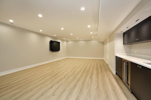 interior space with light wood-type flooring, baseboards, and recessed lighting