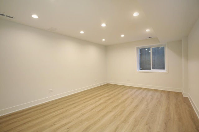 empty room featuring light wood-style floors, baseboards, visible vents, and recessed lighting