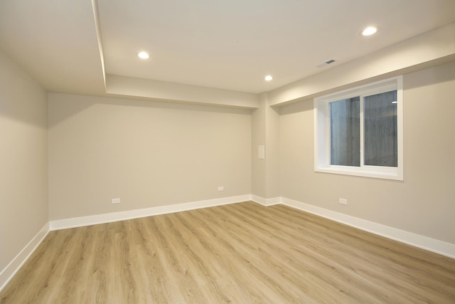 spare room with recessed lighting, light wood-type flooring, and baseboards