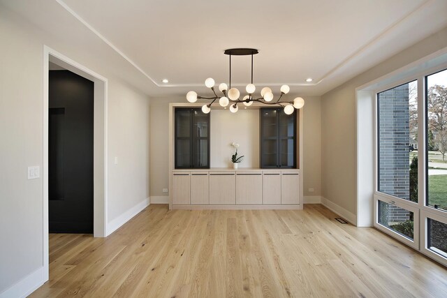 interior space featuring a towering ceiling and light hardwood / wood-style floors