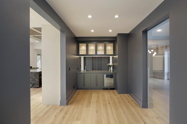 hall featuring sink, wine cooler, and light hardwood / wood-style flooring